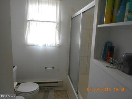 105 East Fourteenth Avenue Ranson, WV 25438 - Photo 10 of 17 a bathroom with a toilet a sink and a window