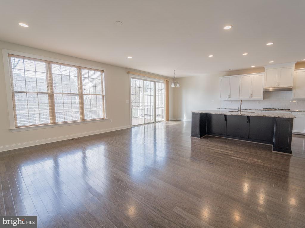 22595 Windsor Locks Square Ashburn, VA 20148 - Photo 11 of 56 an empty room with wooden floor and windows