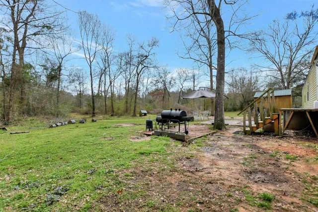 a view of a backyard with table and chairs and a fire pit