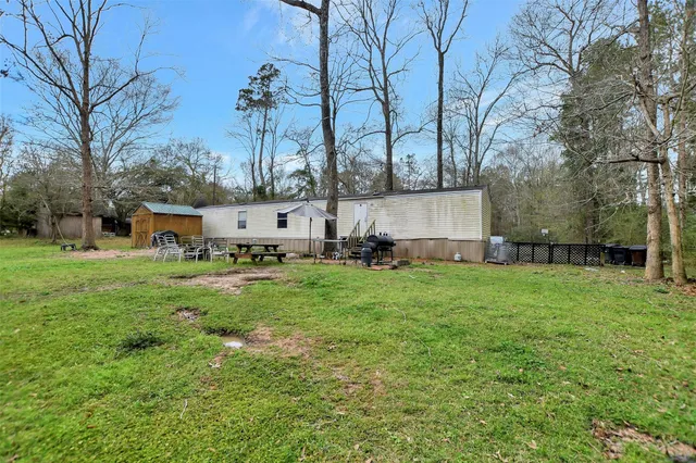 a view of backyard with fountain and large trees