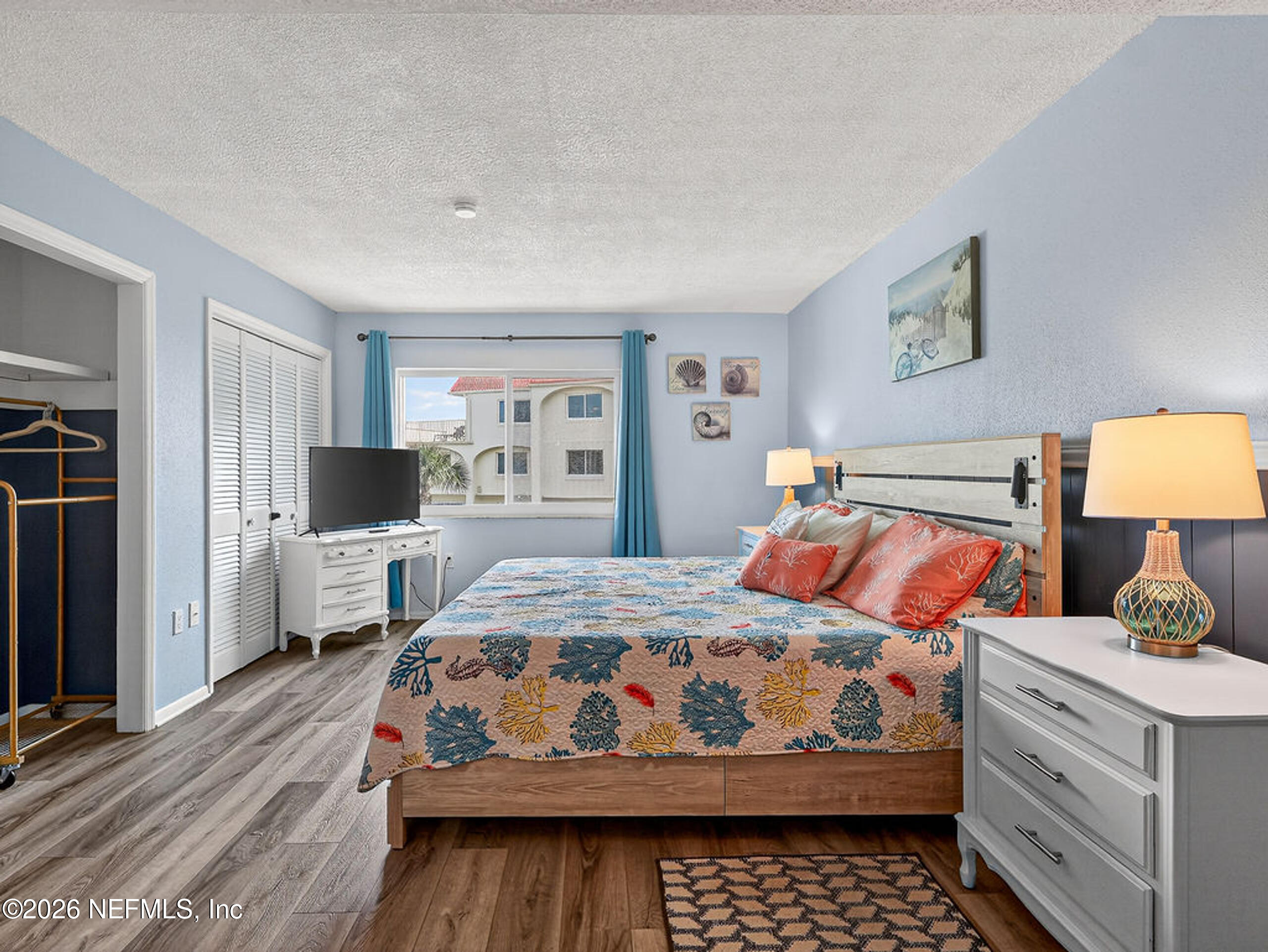 1 Ocean Trace Road, Unit 230 St. Augustine Beach, FL 32080 - Photo 20 of 50 a bedroom with a bed and a dresser in it