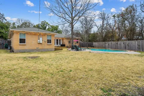 a swimming pool view with a outdoor seating