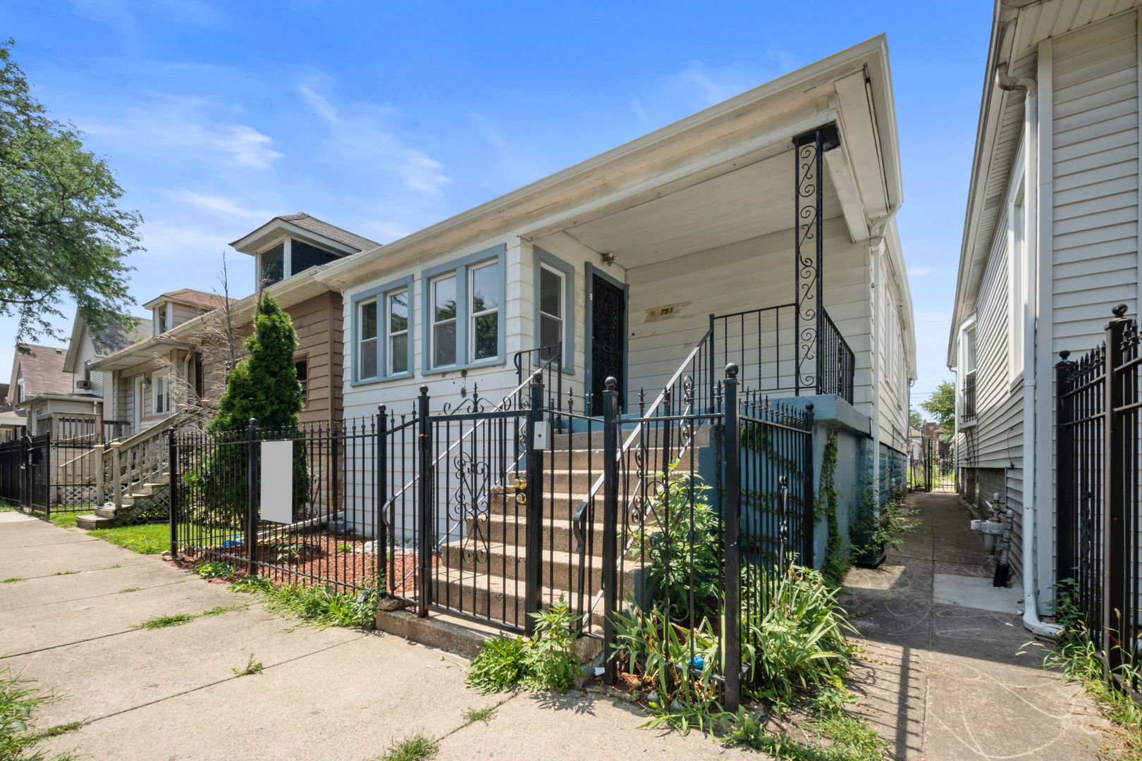 a front view of a house with a garden