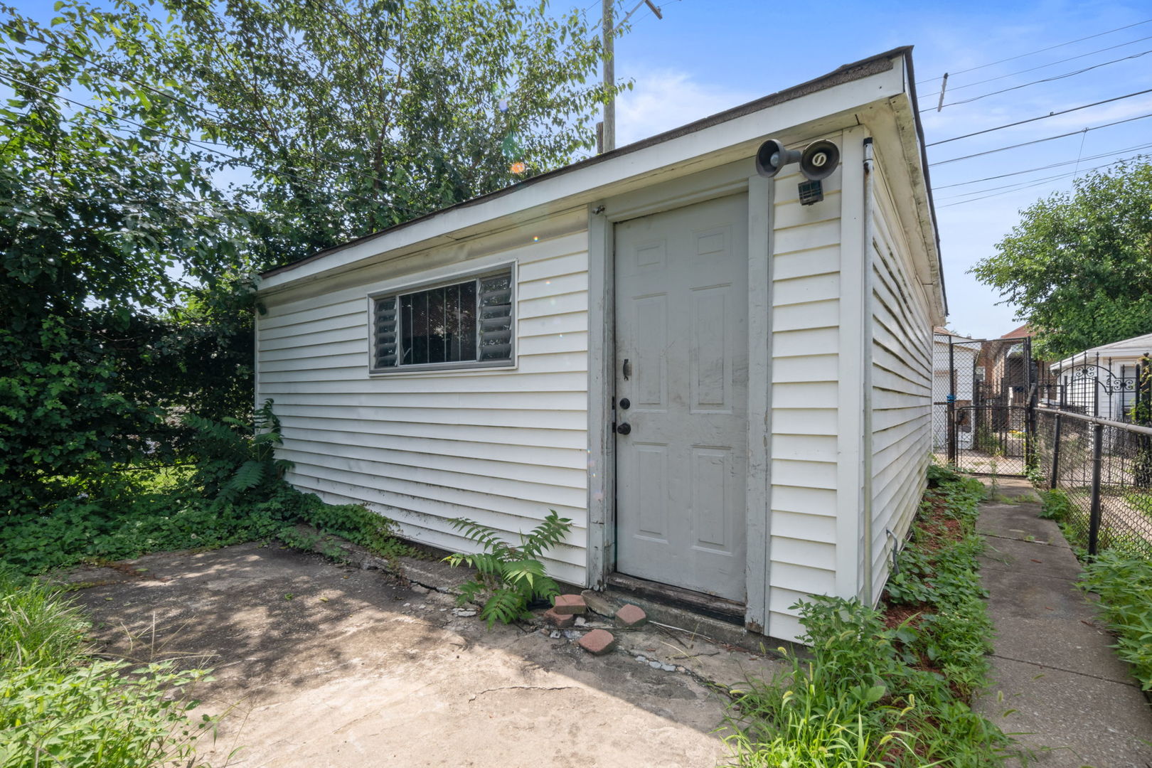 7518 South Rhodes Avenue Chicago, IL 60619 - Photo 12 of 12 a backyard of a house with plants and tree