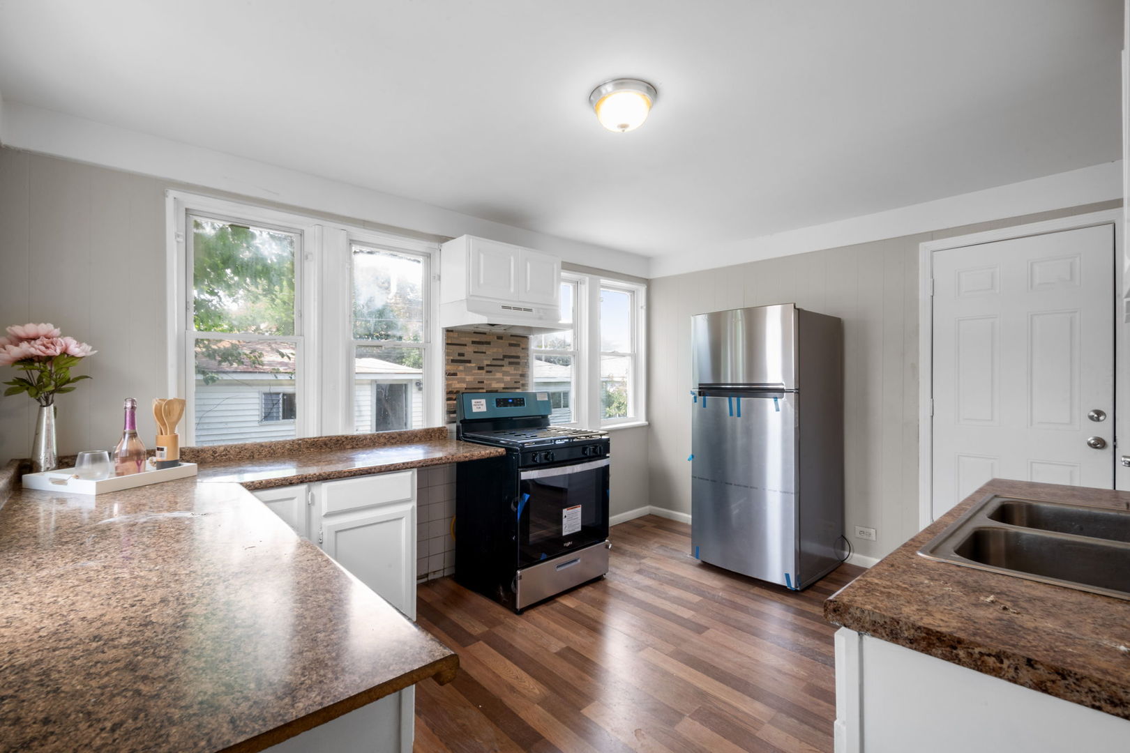 7518 South Rhodes Avenue Chicago, IL 60619 - Photo 2 of 12 a kitchen with granite countertop a refrigerator stove and sink