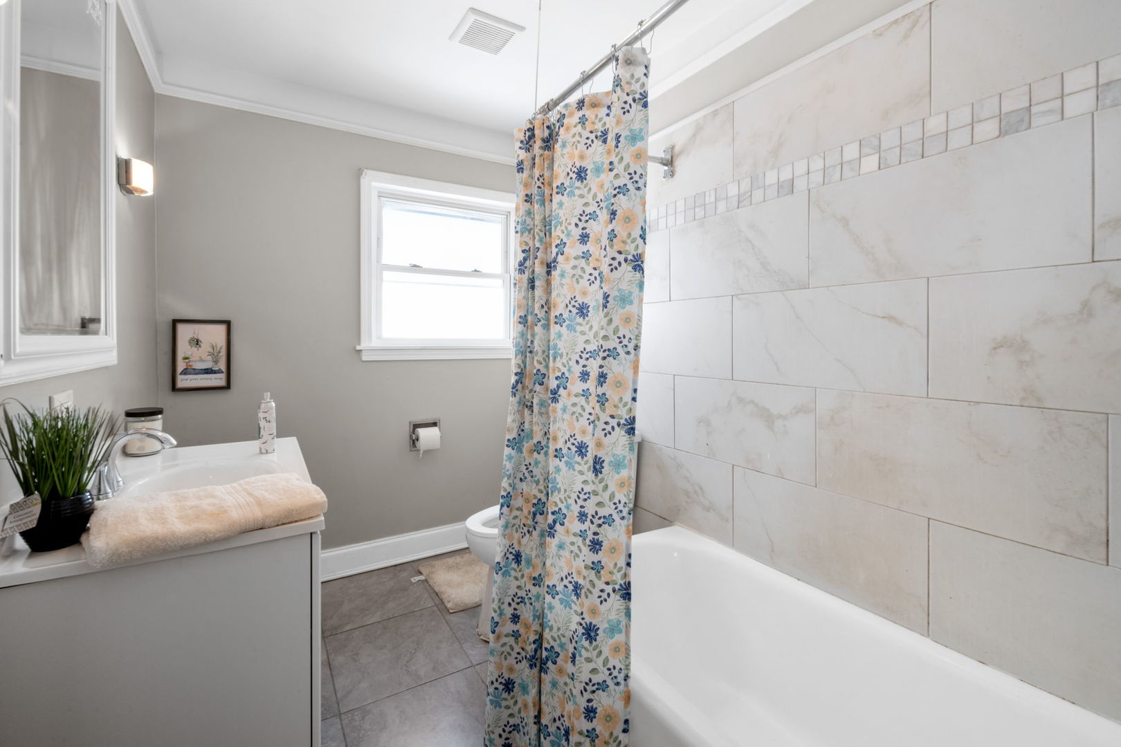 7518 South Rhodes Avenue Chicago, IL 60619 - Photo 8 of 12 a bathroom with a bathtub a sink and a shower