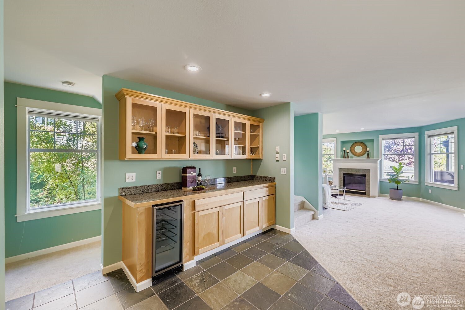 2622 East Madison Street Seattle, WA 98112 - Photo 11 of 38 a view of a kitchen with a sink a fireplace and windows