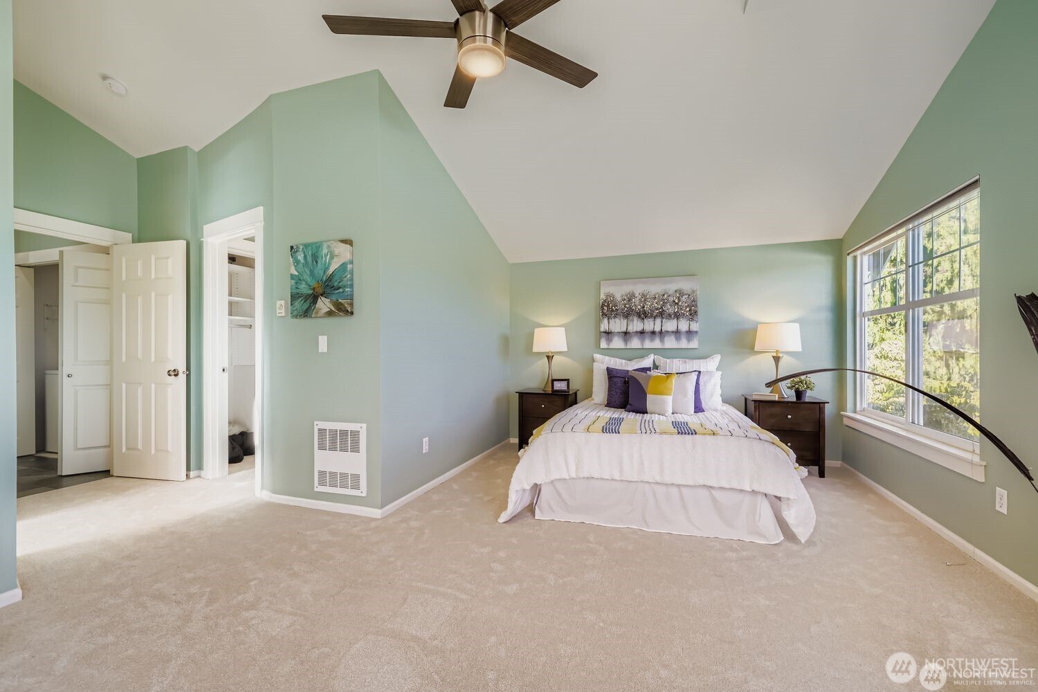 2622 East Madison Street Seattle, WA 98112 - Photo 14 of 38 a bedroom with a large bed and a chandelier