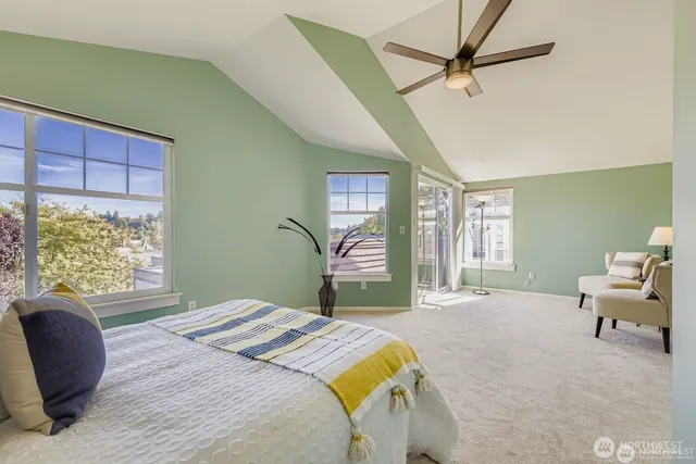 a bedroom with a large bed and a chair