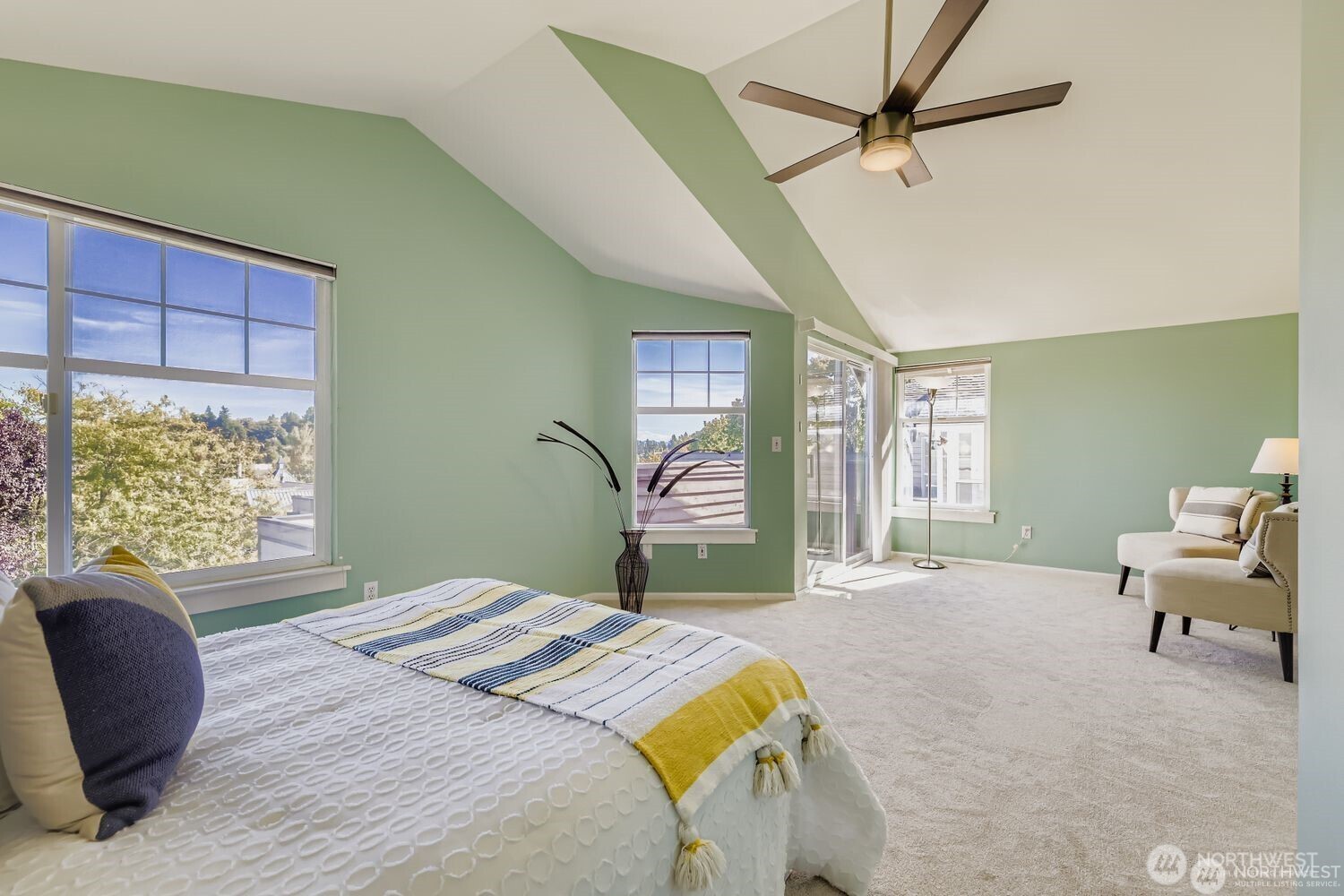 2622 East Madison Street Seattle, WA 98112 - Photo 16 of 38 a bedroom with a large bed and a chair