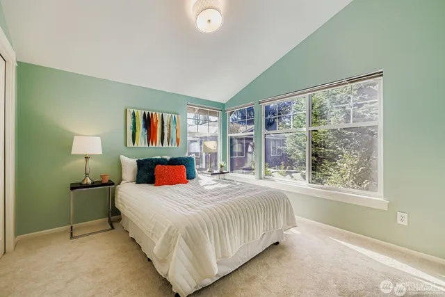 a bedroom with a large bed and a window