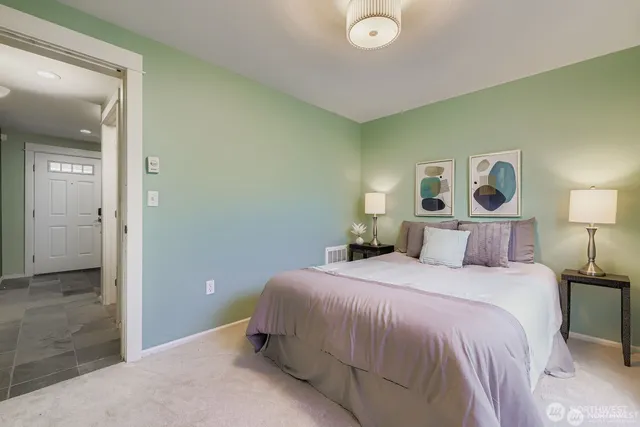 a bedroom with a bed and a mirror