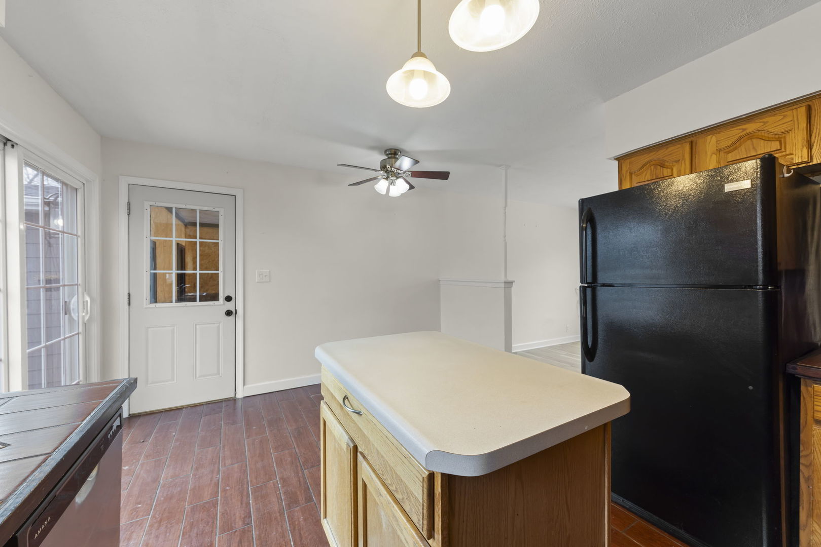 422 Best Avenue DeKalb, IL 60115 - Photo 11 of 34 a kitchen that has a refrigerator a stove and white cabinets with wooden floor