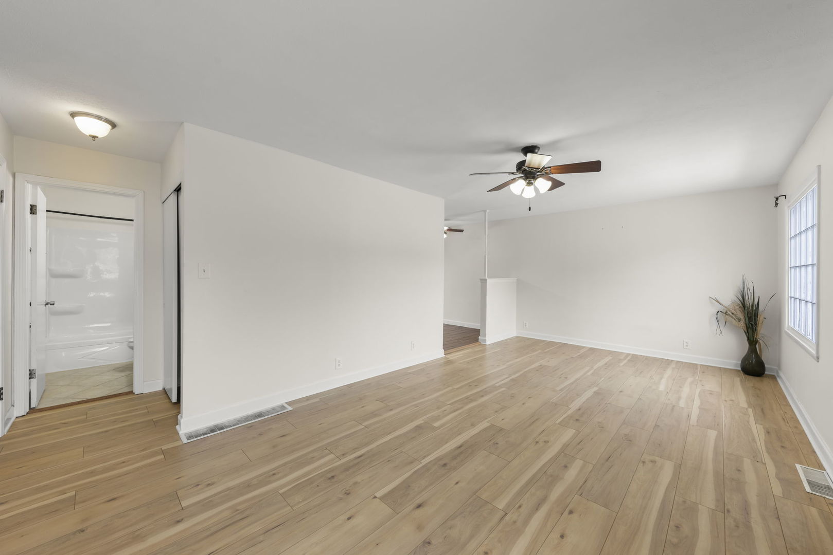 422 Best Avenue DeKalb, IL 60115 - Photo 2 of 34 a view of empty room with wooden floor and fan