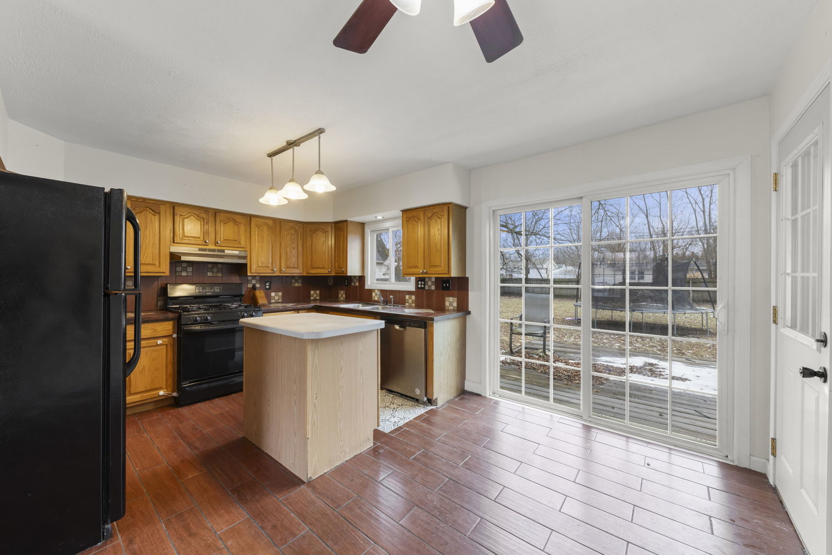 422 Best Avenue DeKalb, IL 60115 - Photo 8 of 34 a kitchen with kitchen island wooden floors appliances and cabinets