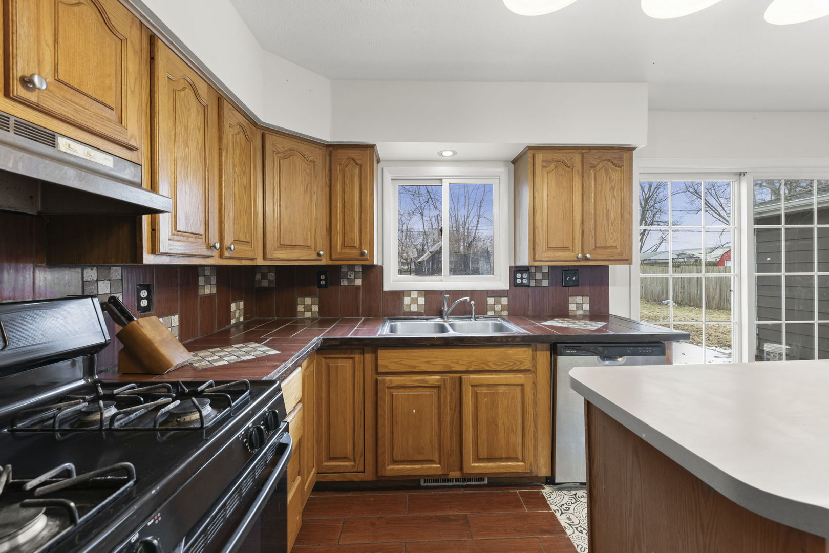 422 Best Avenue DeKalb, IL 60115 - Photo 10 of 34 a kitchen with a sink stove top oven and cabinets