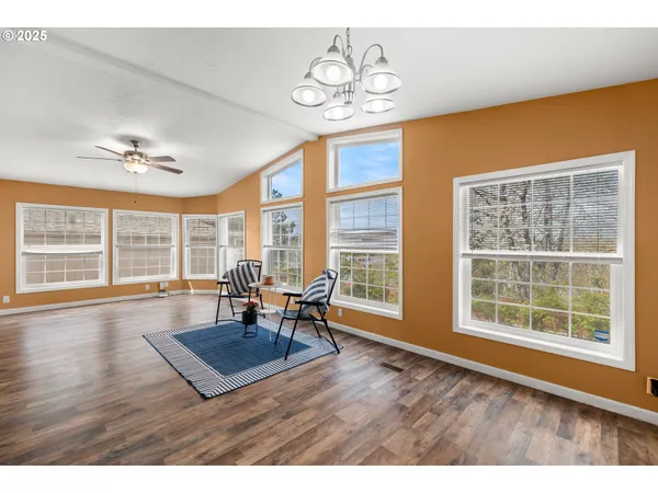a view of a dining room with furniture wooden floor and chandelier