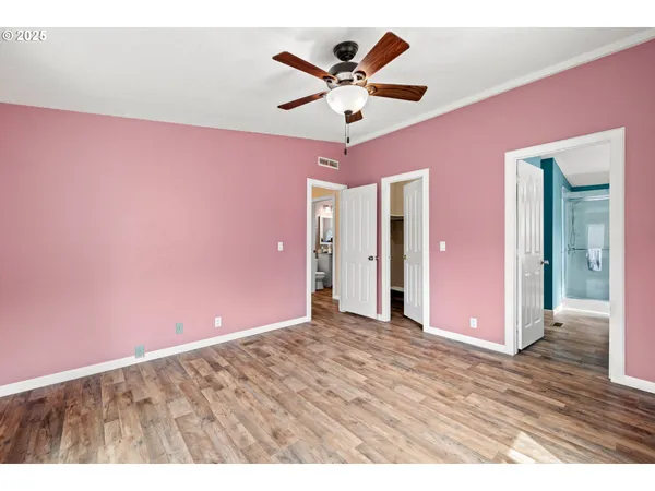 a view of a livingroom with a ceiling fan & a ceiling fan