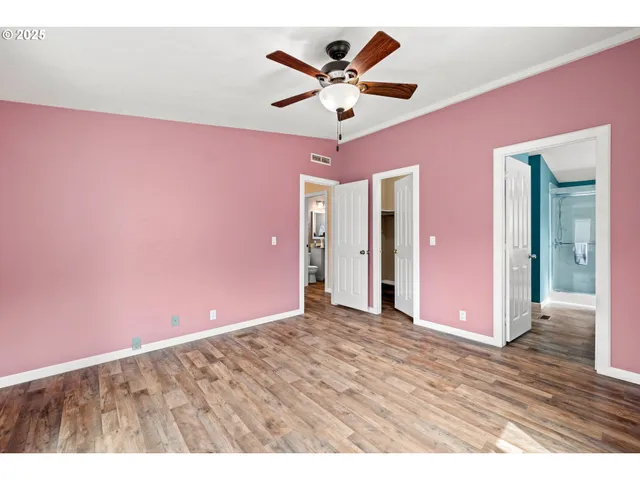 a view of a livingroom with a ceiling fan & a ceiling fan