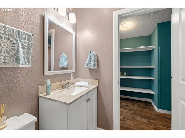 a bathroom with a sink vanity and a mirror