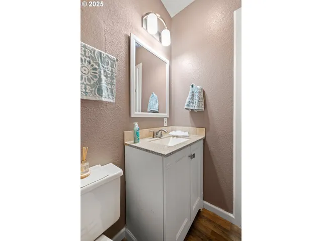 a bathroom with a sink a toilet and mirror