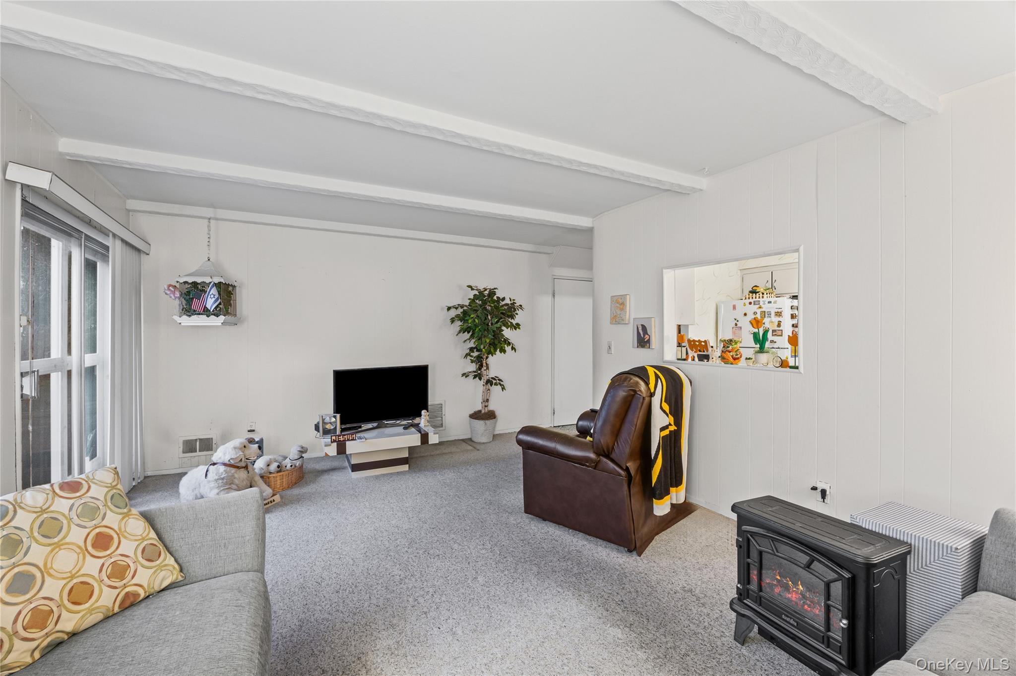 2929 Mandalay Beach Road Wantagh, NY 11793 - Photo 11 of 26 a living room with furniture and a flat screen tv