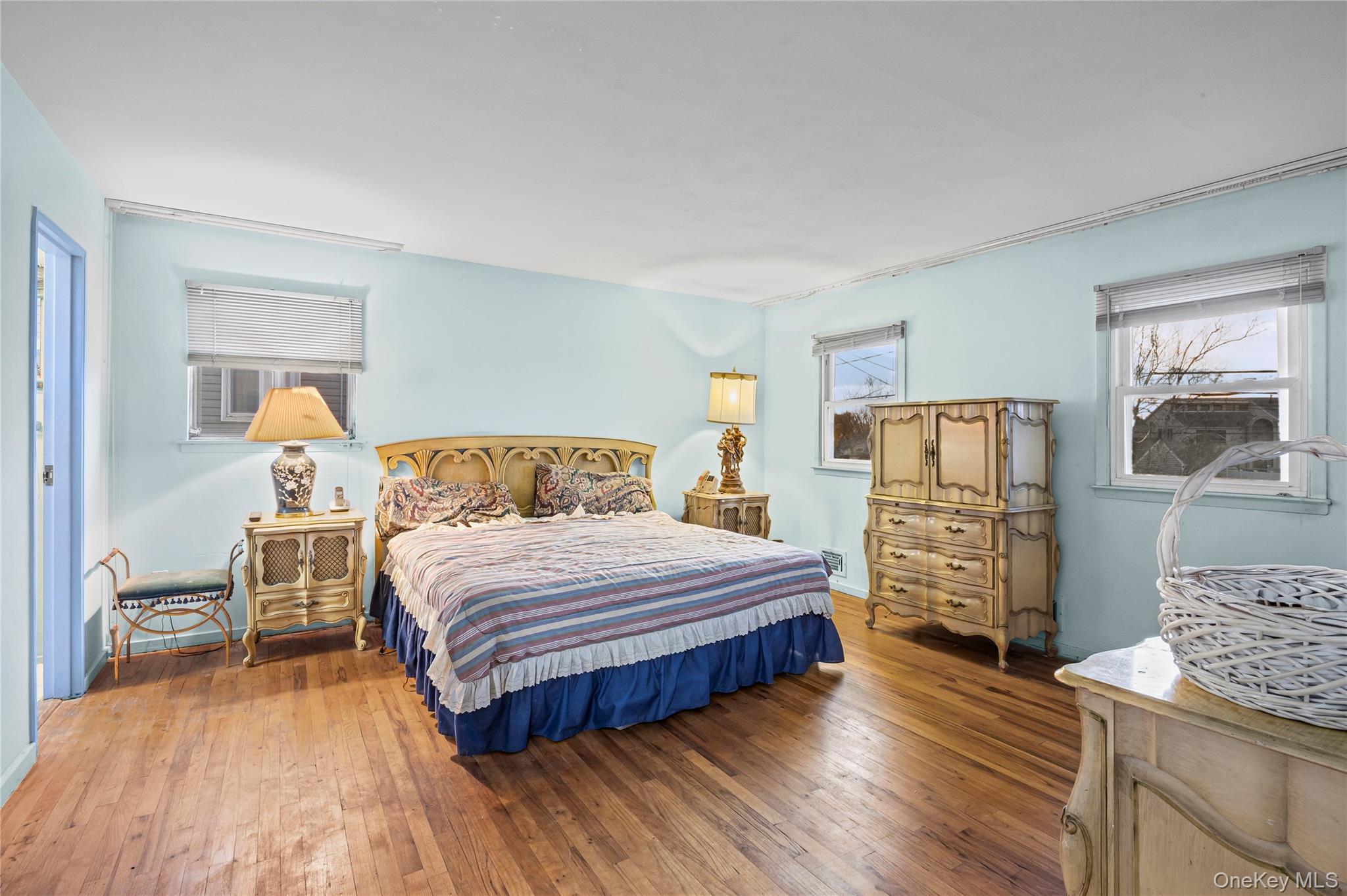 2929 Mandalay Beach Road Wantagh, NY 11793 - Photo 15 of 26 a bedroom with a bed and wooden floor