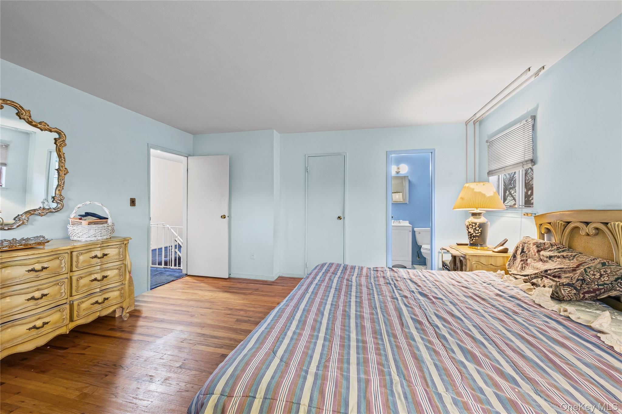 2929 Mandalay Beach Road Wantagh, NY 11793 - Photo 16 of 26 a bedroom with a bed and wooden floor