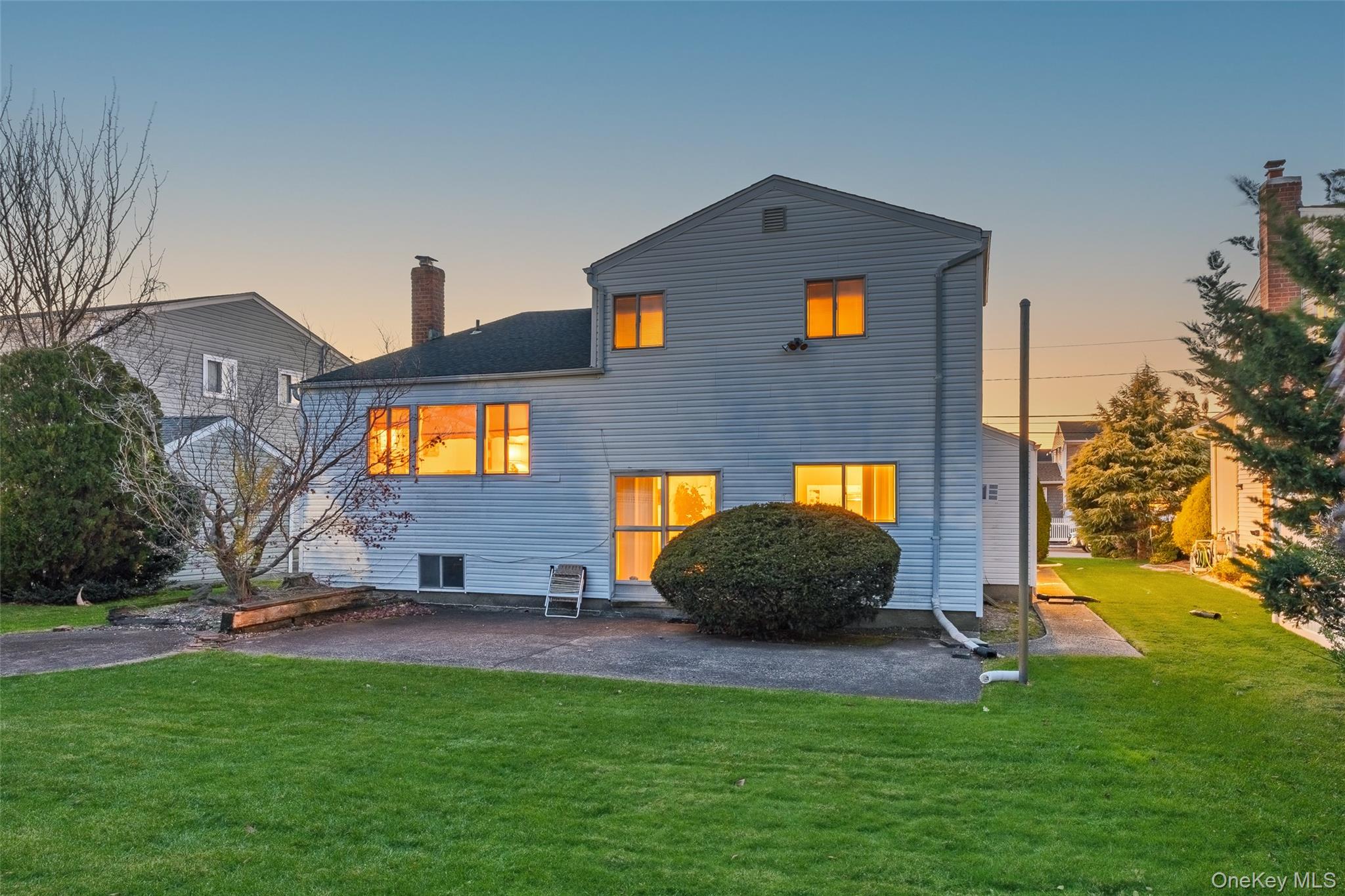 2929 Mandalay Beach Road Wantagh, NY 11793 - Photo 21 of 26 a front view of a house with a yard