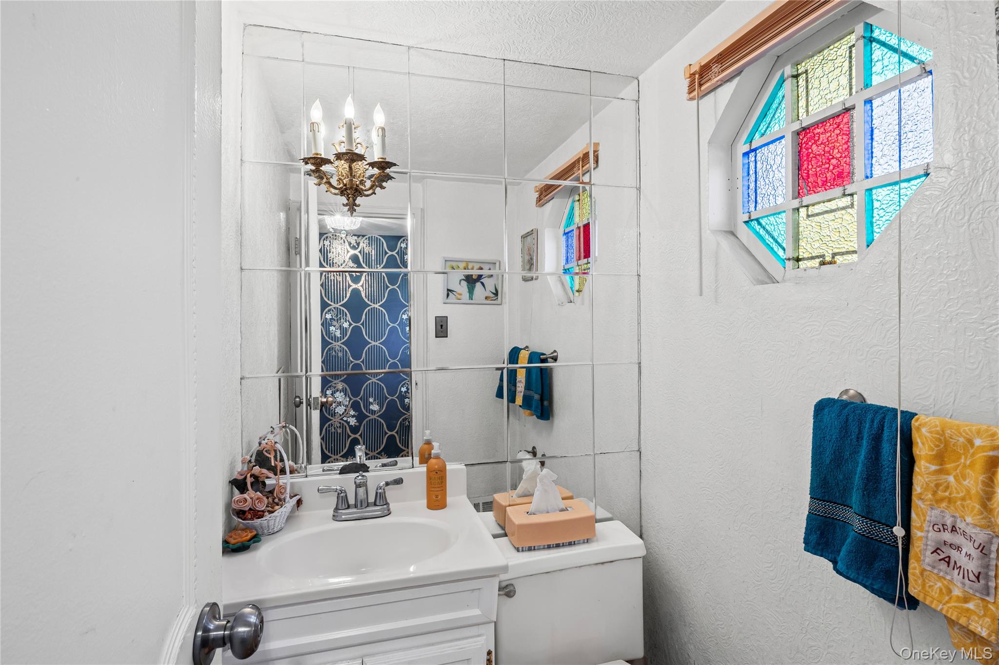 2929 Mandalay Beach Road Wantagh, NY 11793 - Photo 9 of 26 a bathroom with a sink mirror and vanity