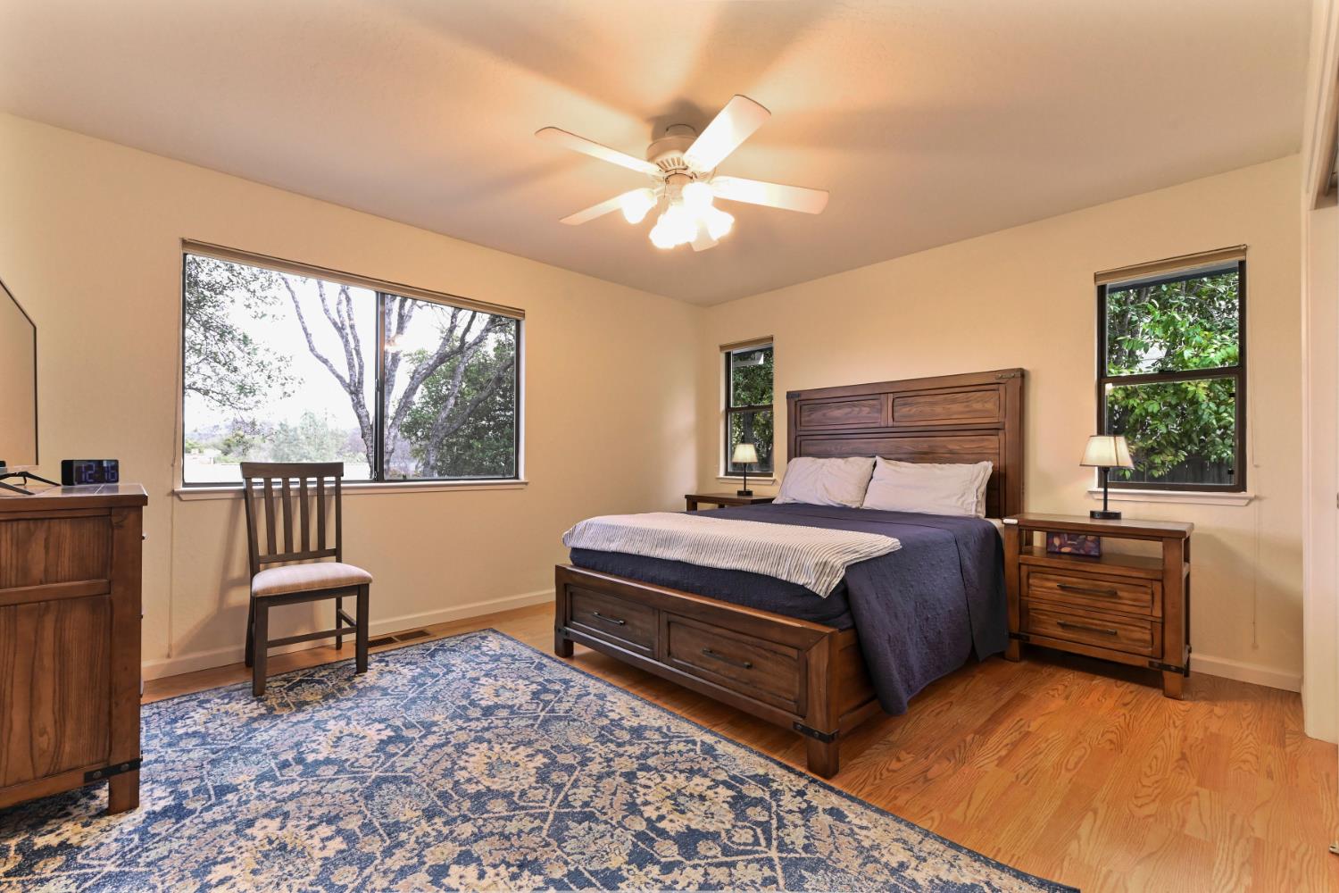 147 Rocky Ridge Lane Angels Camp, CA 95222 - Photo 26 of 61 a bedroom with a bed and a chandelier