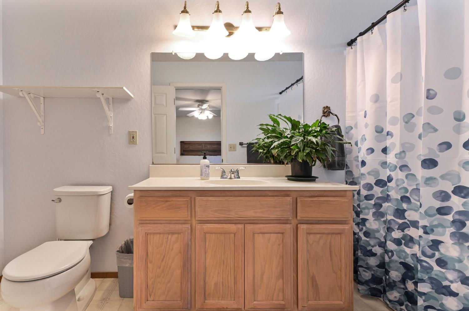 147 Rocky Ridge Lane Angels Camp, CA 95222 - Photo 30 of 61 a bathroom with a granite countertop sink a toilet and a mirror