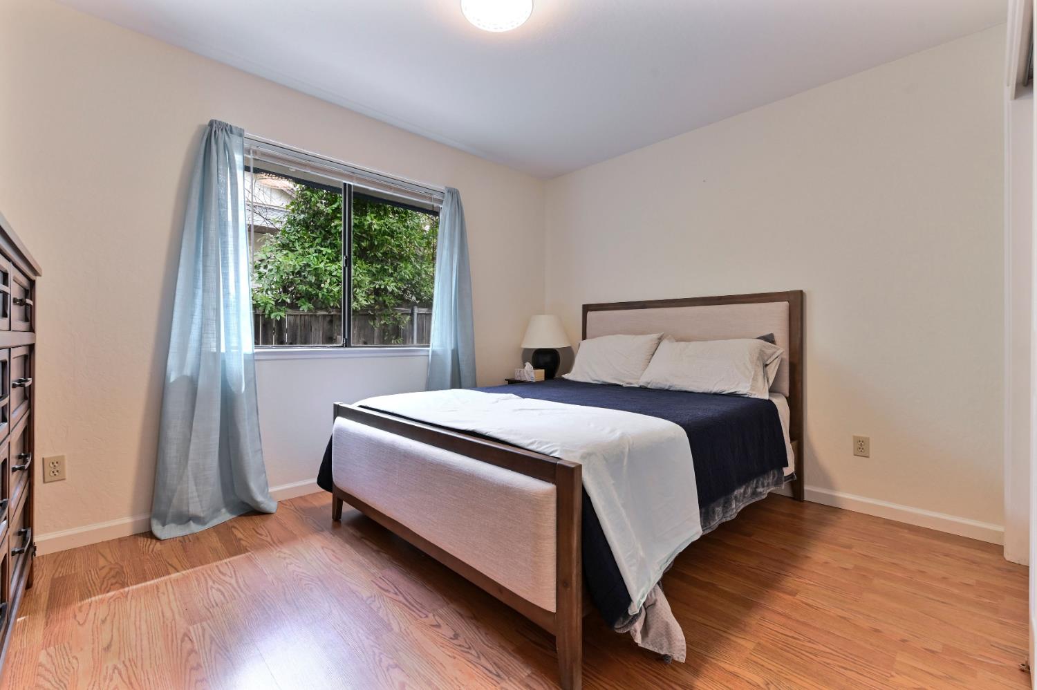 147 Rocky Ridge Lane Angels Camp, CA 95222 - Photo 33 of 61 a bedroom with a bed and wooden floor