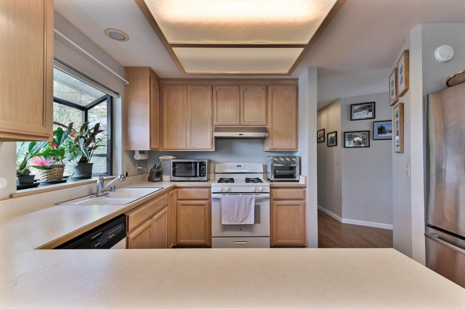 147 Rocky Ridge Lane Angels Camp, CA 95222 - Photo 51 of 61 a kitchen with stainless steel appliances granite countertop a refrigerator sink and stove