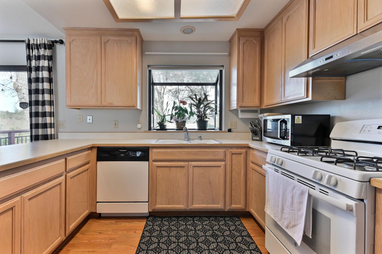 147 Rocky Ridge Lane Angels Camp, CA 95222 - Photo 53 of 61 a kitchen with a sink stove and cabinets