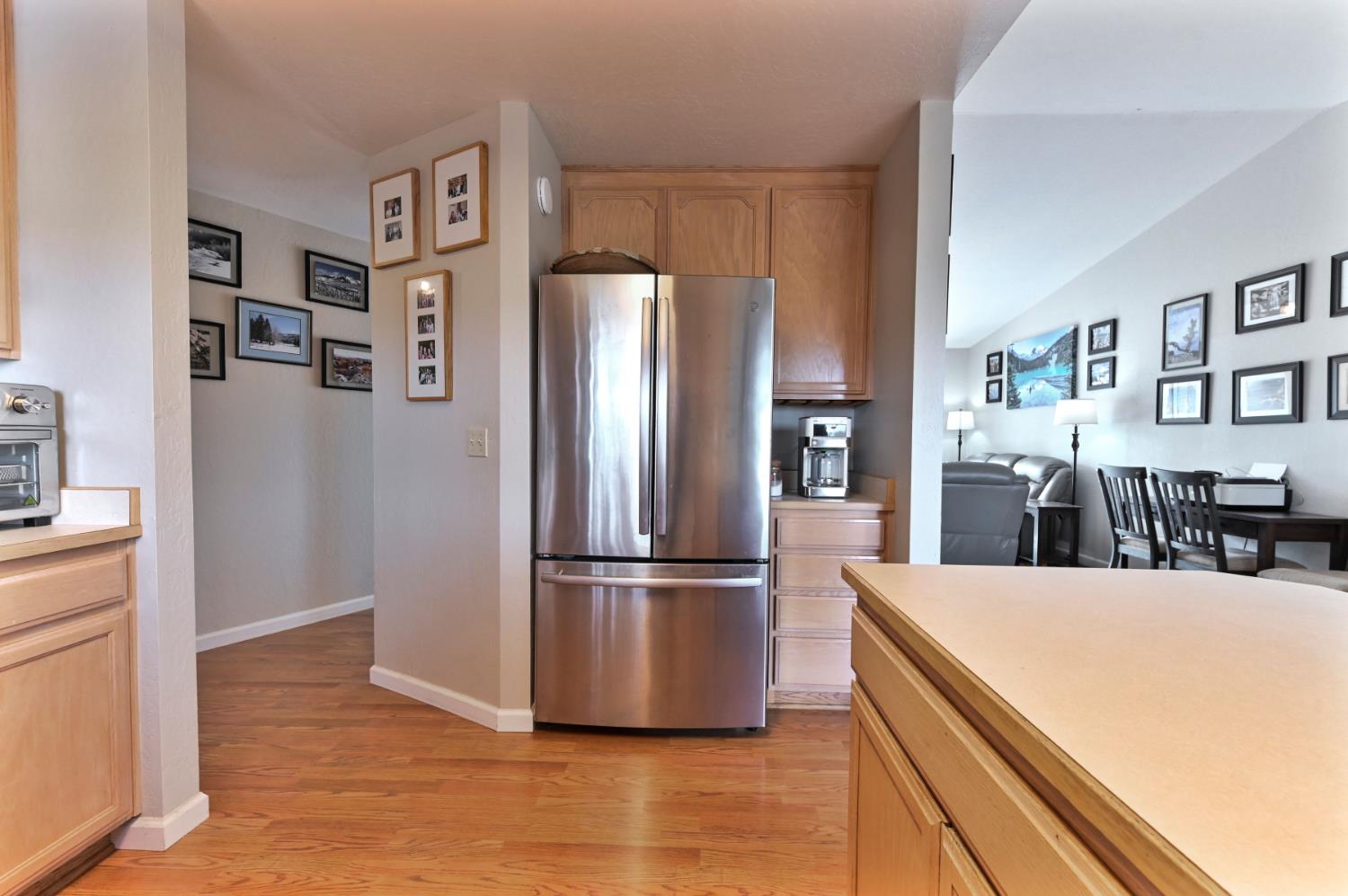 147 Rocky Ridge Lane Angels Camp, CA 95222 - Photo 55 of 61 a kitchen with stainless steel appliances a refrigerator and wooden floor