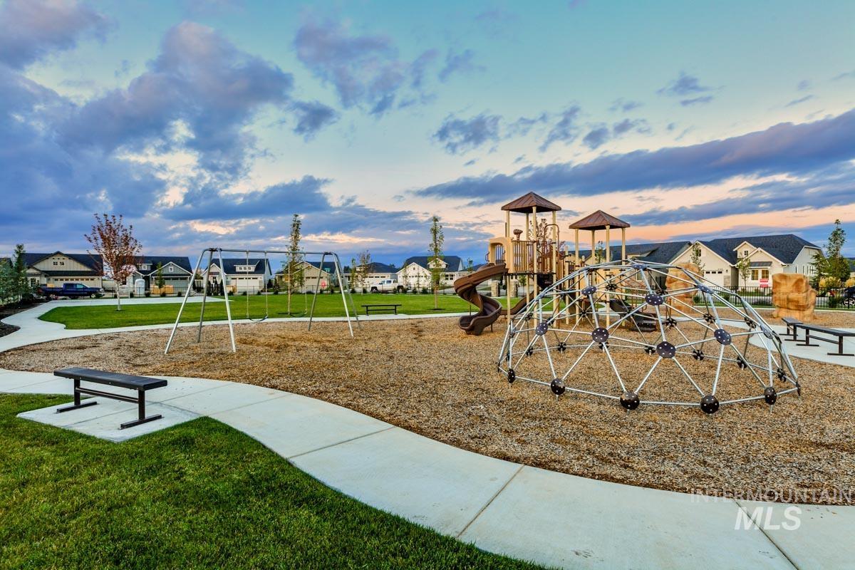 348 West Radiant Rdg Drive Meridian, ID 83642 - Photo 32 of 36 Playground at dusk featuring a residential view and a lawn