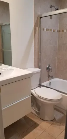a white toilet sitting next to a bathroom sink