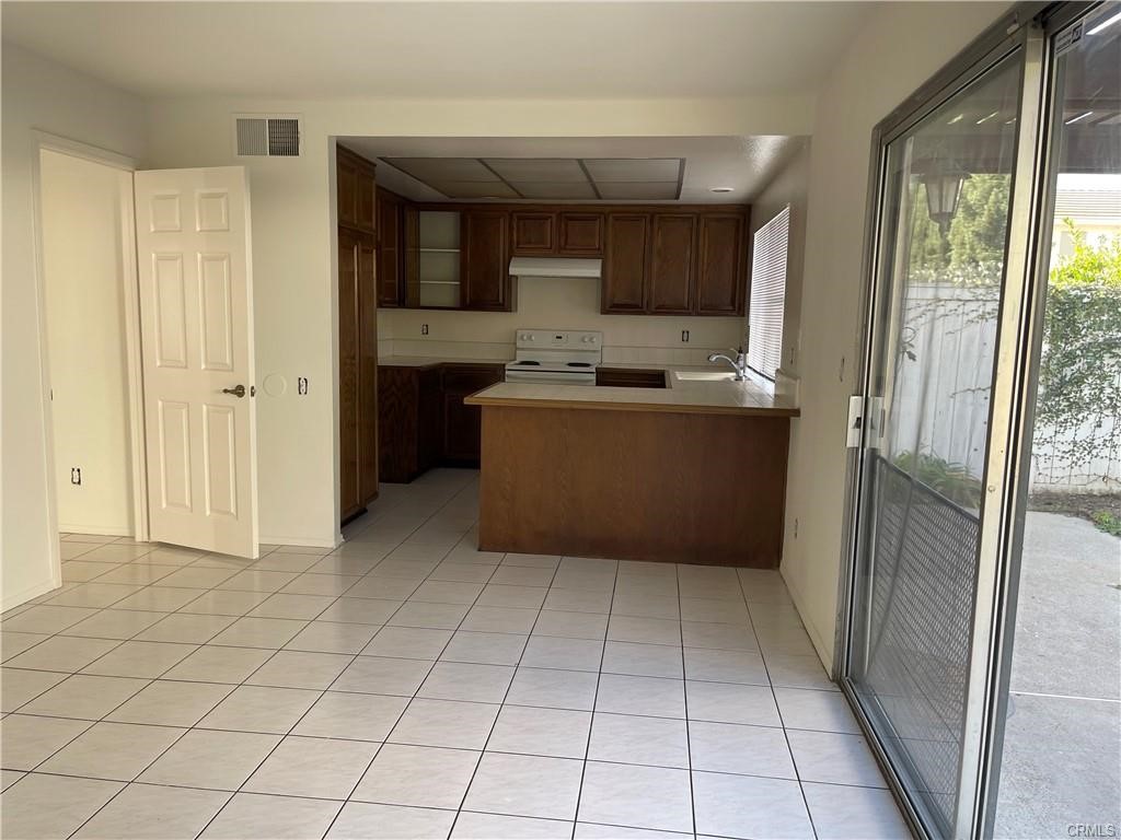 8 Marsh Hawk Irvine, CA 92604 - Photo 2 of 13 a kitchen with stainless steel appliances a refrigerator and a counter top space