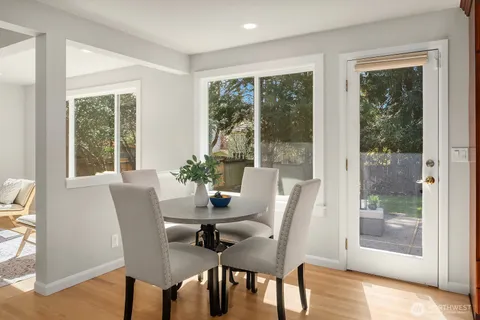 a dining room with furniture window and wooden floor