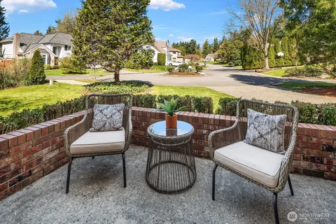 a view of a patio with furniture and a yard