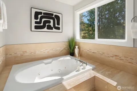 a bathroom with a bathtub and window