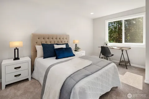 a bedroom with a bed and a table