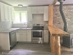 320 East River Road Chester, MA 01011 - Photo 25 of 34 a kitchen with a stove sink and cabinets