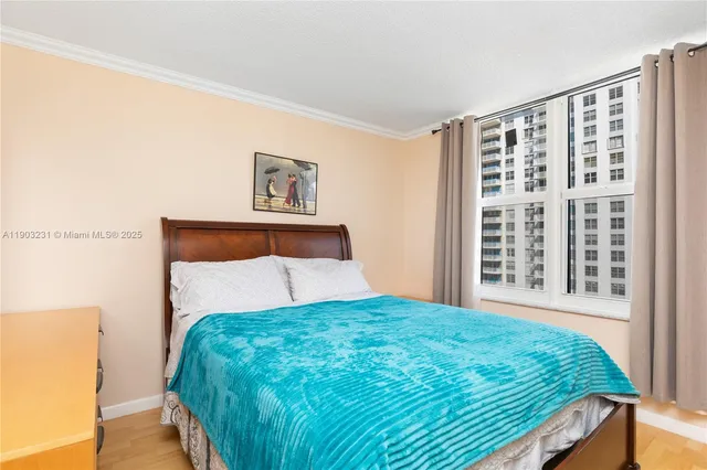 a bedroom with a large bed and a large window