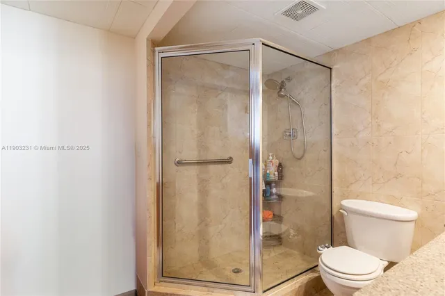 a bathroom with a glass shower door