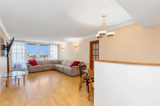 a living room with furniture and a chandelier