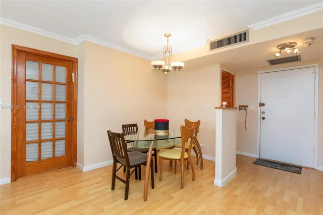 a view of a room with furniture and wooden floor