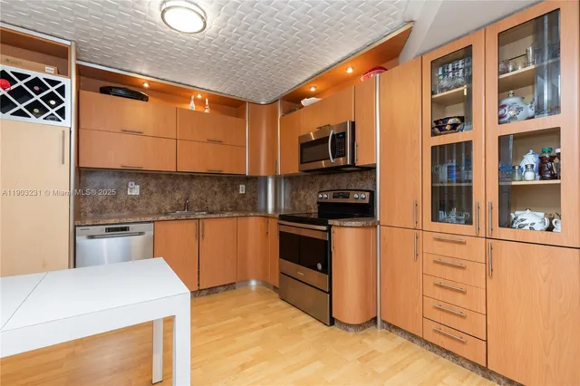 a kitchen with stainless steel appliances granite countertop a stove and a sink