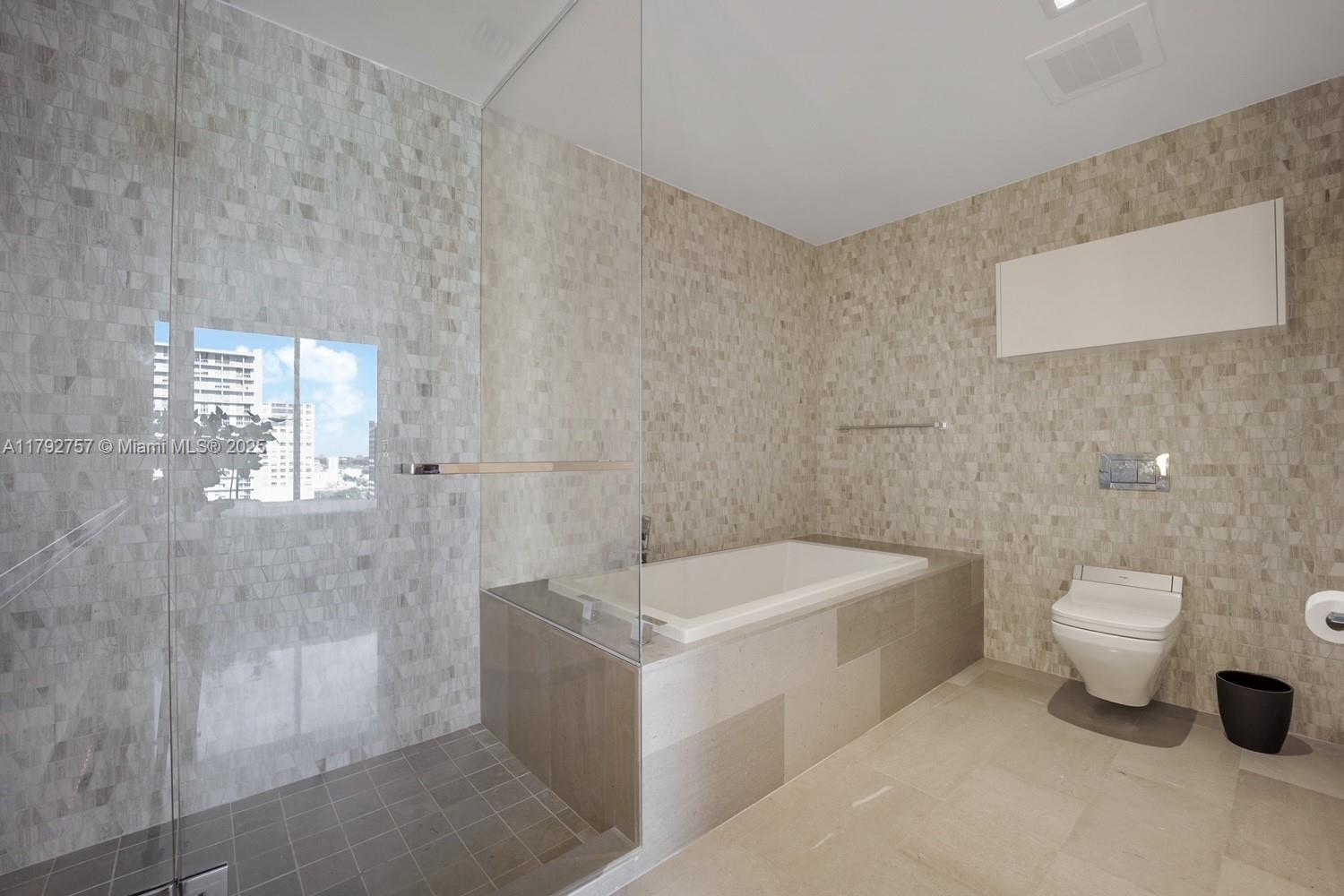 68 Southeast 6th Street, Unit 1204 Miami, FL 33131 - Photo 14 of 48 a bathroom with a sink a toilet and shower